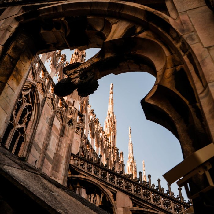 A vertical shot of a beautiful view of Duomo di Milano and an antique arch in Milan, Italy